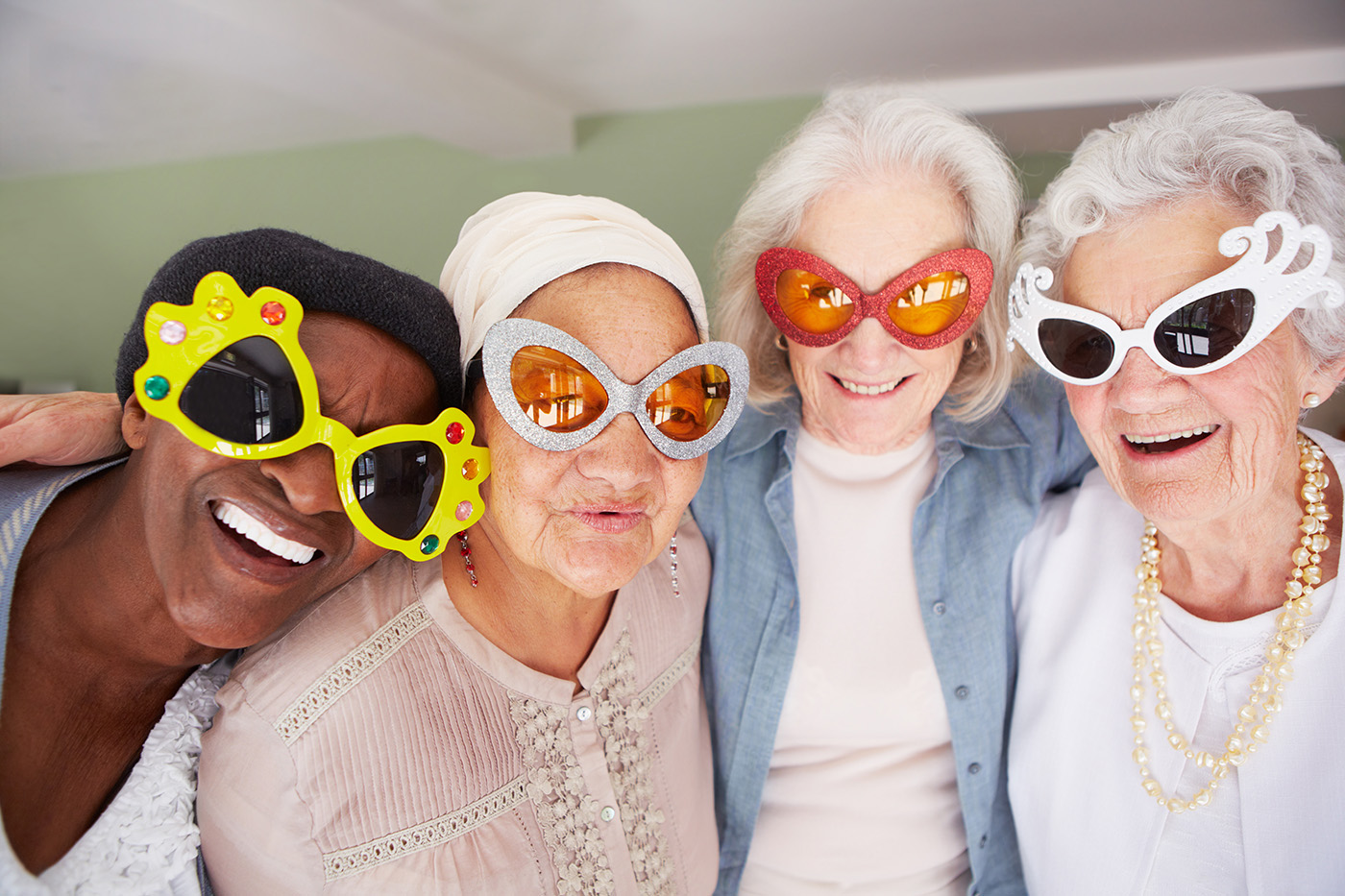 Older women in silly glasses having fun